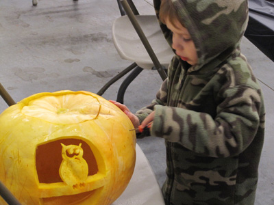 putting the finishing touches on the pumpkin daddy carved.