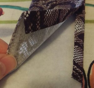 Pressing the strap fabric around the strap padding.